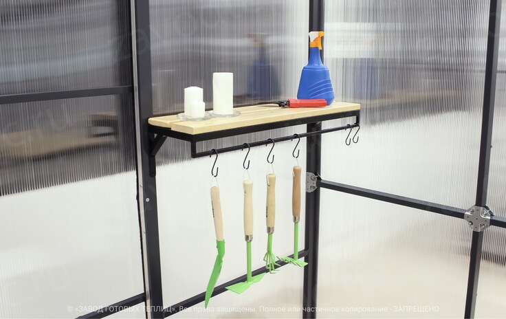 Shelf in the greenhouse with garden appliances