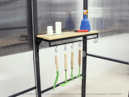 Shelf in the greenhouse with garden appliances